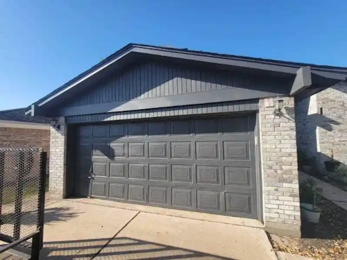 siding and garage door with fresh gray paint